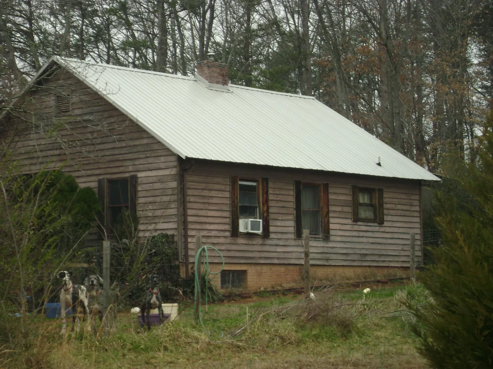 White metal roof on an old wood sided farmhouse, from a Metal Roof Installation job in Kewanee